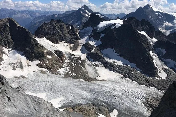 A red Titlis cable car traveling against a snowy mountain backdrop