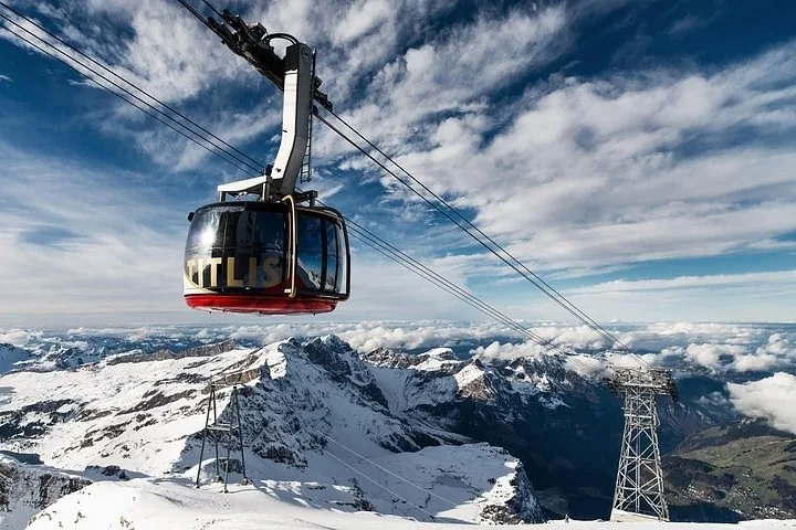 A cable car near Mount Titlis against a bright cloudy sky