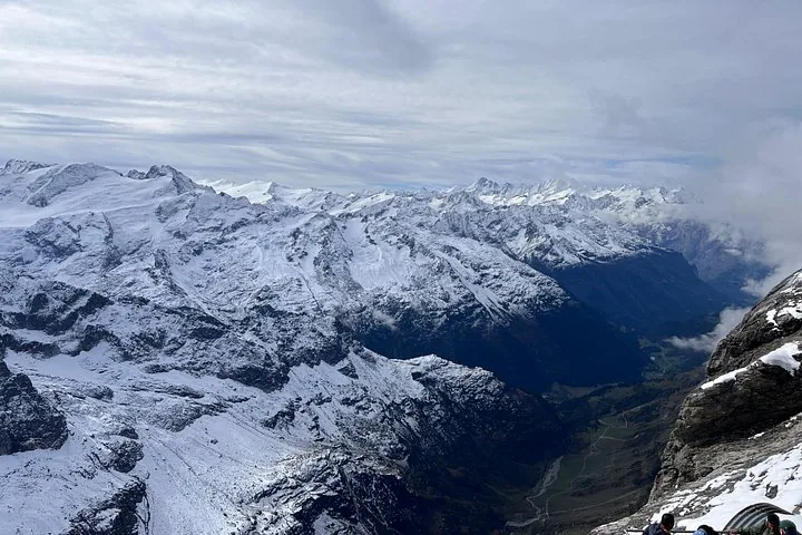 Panoramic view of snow-covered mountain peaks and a valley from Mount Titlis