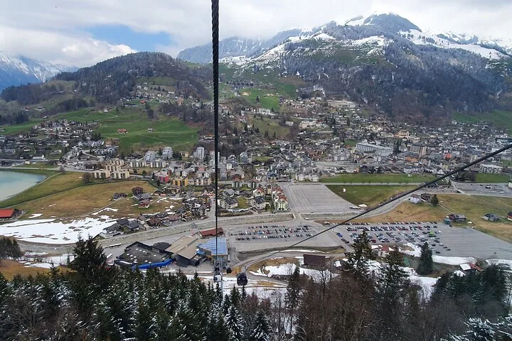 Beautiful alpine landscape showing a green valley surrounded by snowy mountain peaks